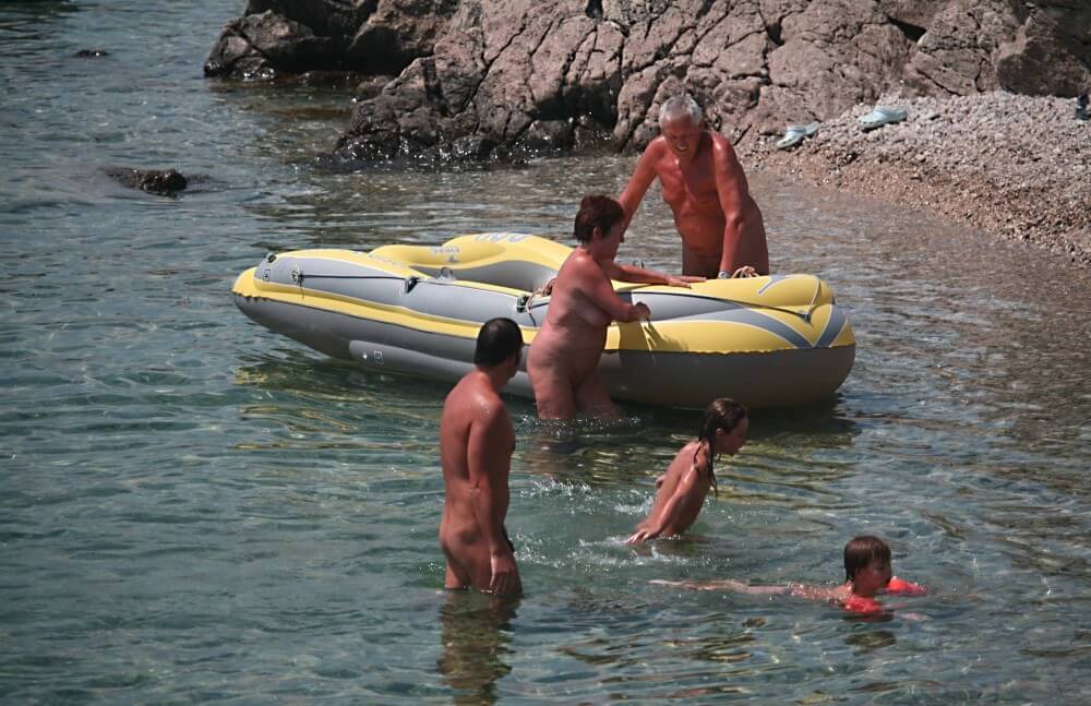 Lone Nudist in Yellow Boat photos - A closed community of naturists