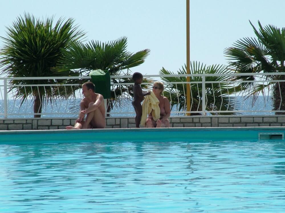 Photo of naturists in an outdoor pool - Naturism promotes tolerance